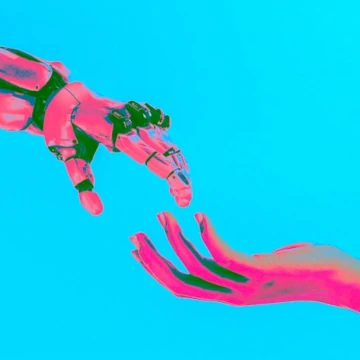 Pink robot and human hands reaching each other. Image: Cash Macanaya on Unsplash.